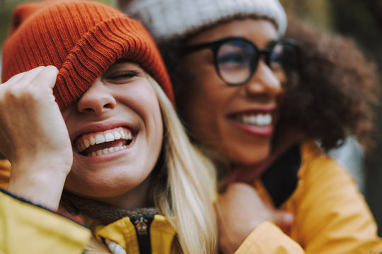 young woman expa laughing happily with new friends